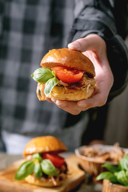 istock Homemade mini burgers with stew beef in hands 1345350227