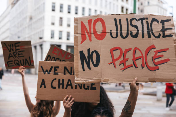 istock Close up on a group of activists holding their protesting messages 1345350627