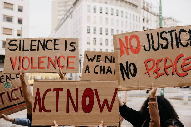 istock Close up on a group of activists holding their protesting messages 1345351468