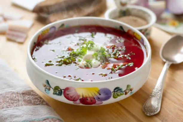 Traditional Ukrainian borscht . Bowl of red beet root soup borsch with white cream . Beet Root delicious soup . Traditional Ukrainian food cuisine