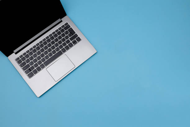 istock Top view isolated laptop on the pastel blue background 1345353010