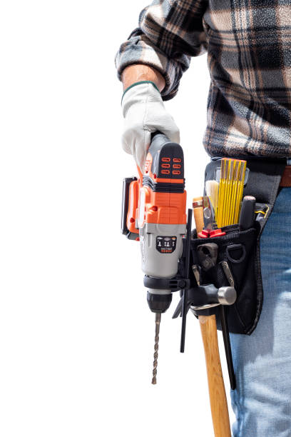 istock Carpenter holding rechargeable hammer drill, isolated on white background. 1345354526