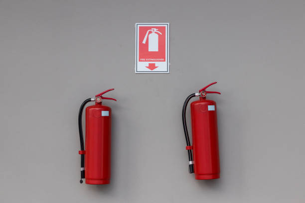 istock Fire extinguisher in the operating department . Install a fire extinguisher on the wall in building. Dry chemical powder fire extinguisher in corridor. a red fire-extinguisher hangs on wall . 1345355551