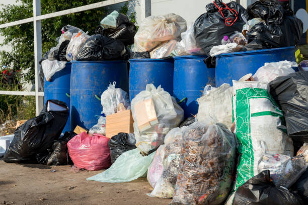 istock Dumpsters being full with garbage.  Overflowing garbage bins with household waste. overflowing blue garbage bin. 1345355563