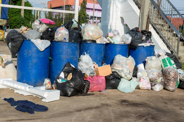 istock Dumpsters being full with garbage.  Overflowing garbage bins with household waste. overflowing blue garbage bin. 1345355568