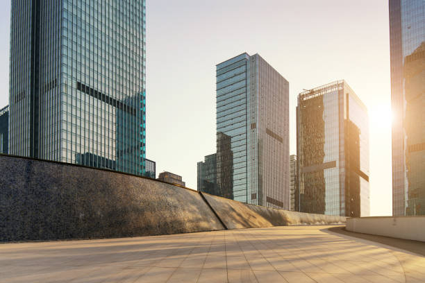 istock empty concrete ground floor with modern cityscape and buildings during sunset. 1345355925