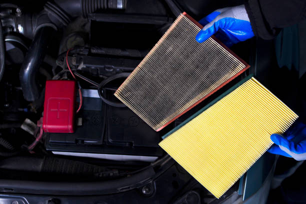 comparison new and used air filter for car with engine background. - air filter car motor vehicle engine imagens e fotografias de stock