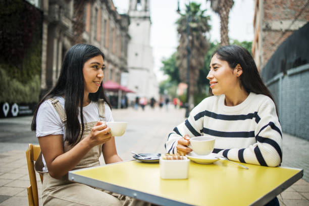 istock Two women sitting at cafe 1345358757