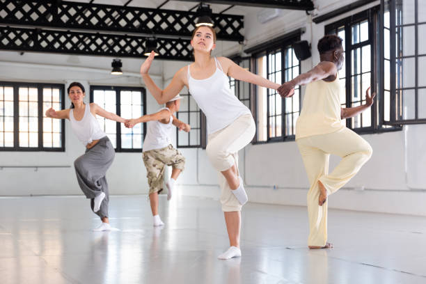istock People dancing twist in pairs in studio 1345358957