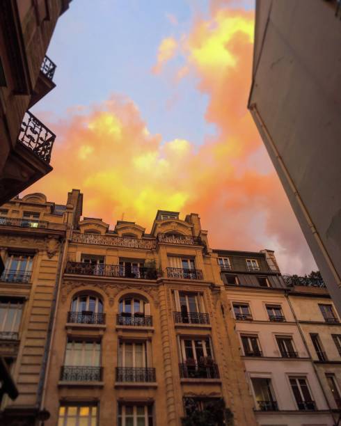 Building in Paris with cloudy sky during sunset, France