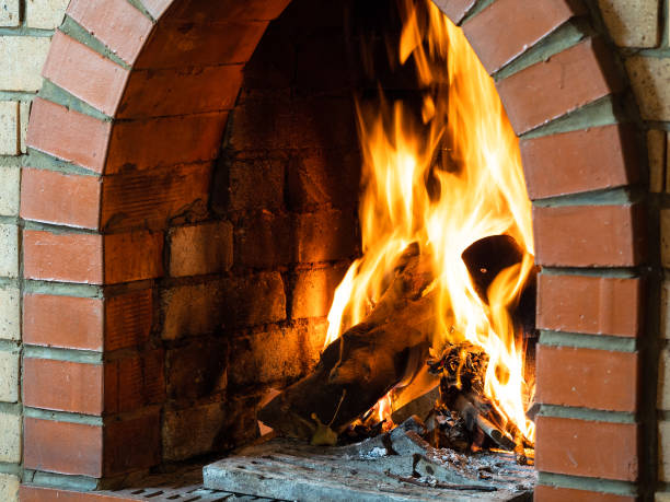 istock fire in fireplace in country house 1345361914
