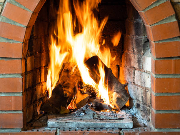 istock front view of fire in brick fireplace in house 1345361917