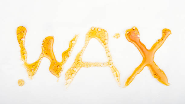 istock golden cannabis wax extract, lettering word on white background 1345363089