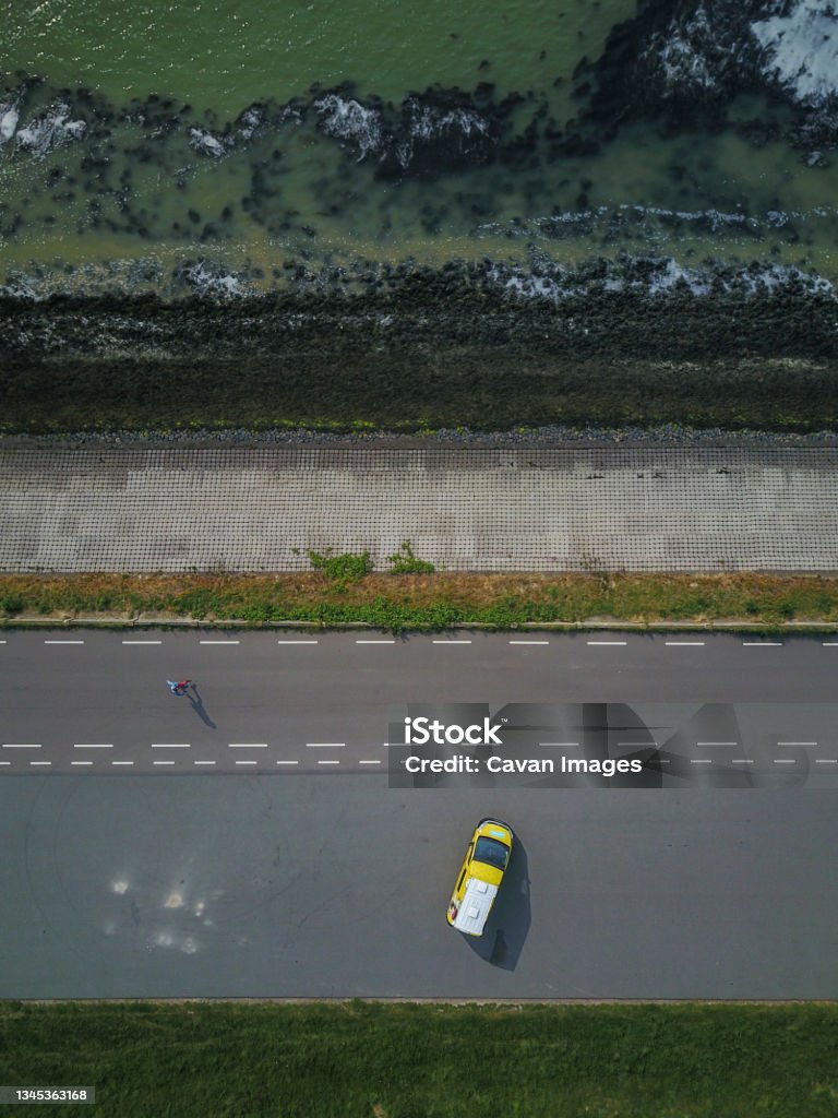 Campervan Parked By the Sea in the Netherlands from above, drone shot Campervan Parked By the Sea in the Netherlands from above, drone shot in The Hague, South Holland, Netherlands Adventure Stock Photo