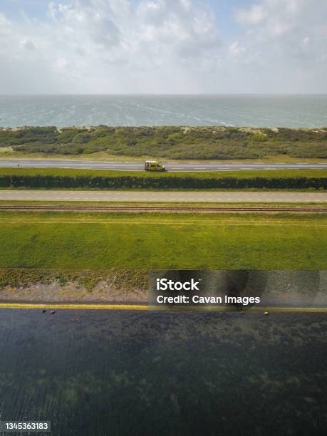 Campervan Parked By The Sea In The Netherlands From Above Drone Shot Stock Photo - Download Image Now