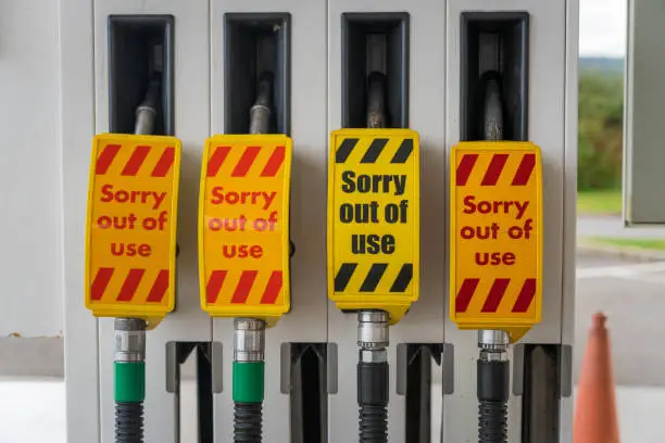 'Sorry Out Of Use' signs on four fuel pumps for unleaded petrol and diesel fuel, during a fuel shortage.