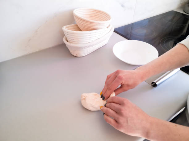 istock Woman kneads dough in the kitchen against the kitchen utensils 1345365061