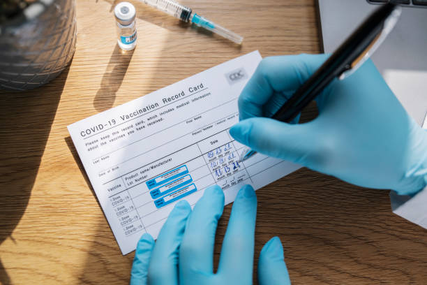 istock Registration Of Covid-19 Vaccination Record Card On Third Dose 1345365376