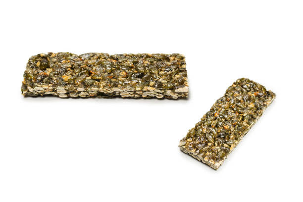 istock Bar with nuts isolated on a white background. Pumpkin seeds bar. 1345368931