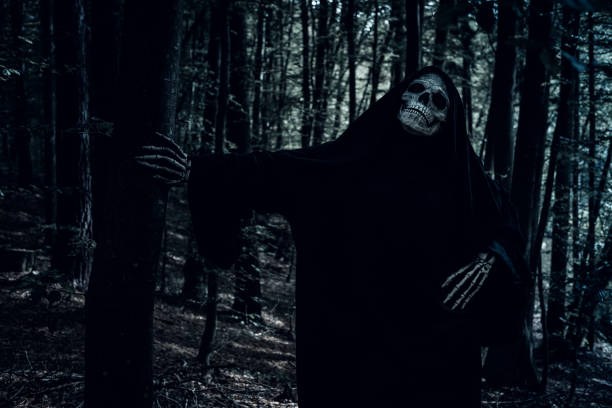 istock Grim Reaper in the forest making funny poses. 1345369076