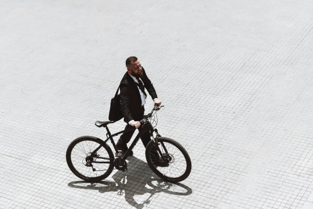 istock High Angle View Of Businessman Pushing Bicycle To Work 1345369323