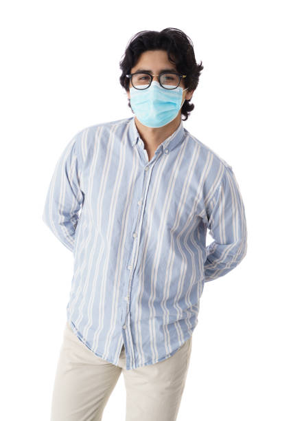 istock Young man with medical mask standing with hands behind his back 1345370155