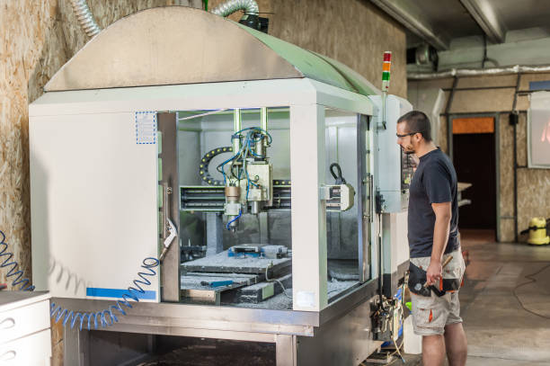 istock Engineer worker technician operating with CNC milling metal engraving machine 1345370354