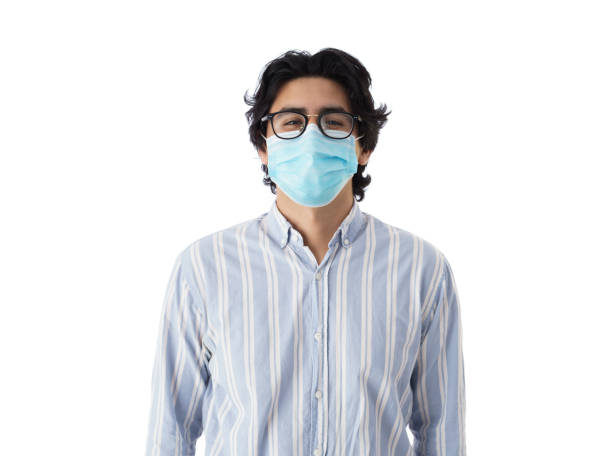 istock Happy young man with face mask looking at camera 1345370408