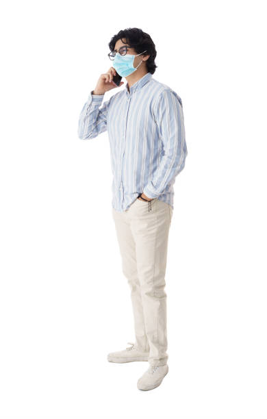 joven con máscara hablando por teléfono - isolated on white full length red protection fotografías e imágenes de stock