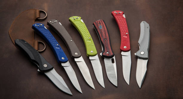 istock Penknives on a leather background. Folding pocket knives. 1345371131