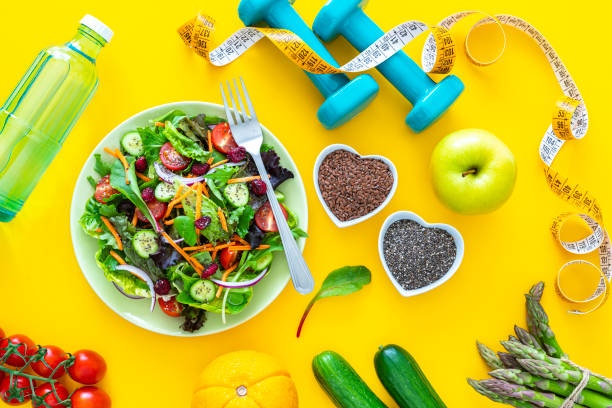 istock Healthy eating and exercising on yellow background 1345371367