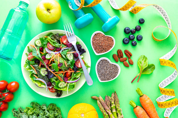 istock Healthy food and exercising on green background 1345371371