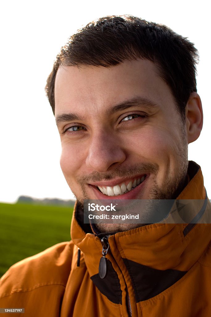 Smiling man Smiling man in orange jacket on white sky background Adult Stock Photo