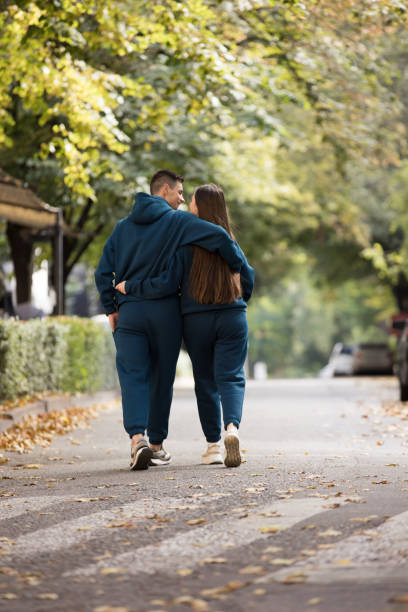 istock Stylish couple walking in the city 1345372977
