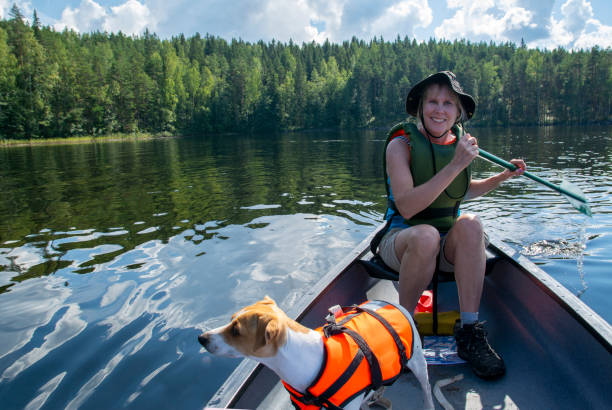 istock Woman canoeing with dog 1345374157