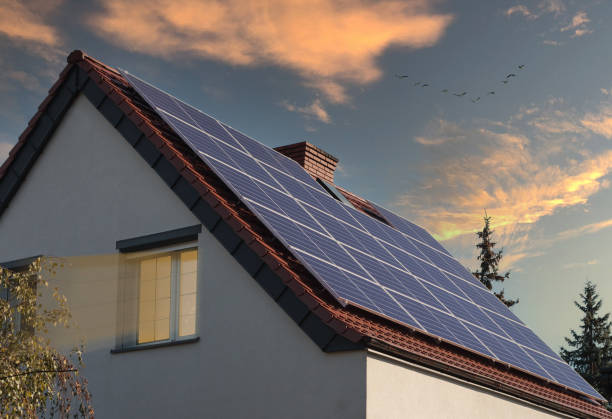 istock Residential building with solar panels at sunset. 1345374725