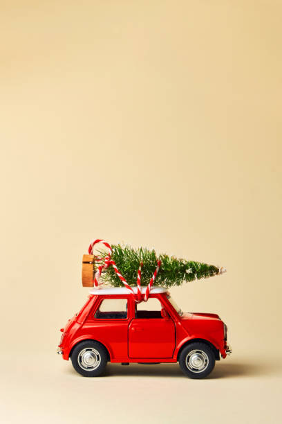 istock Little red toy car and Christmas tree 1345374765