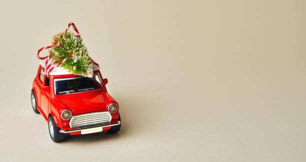 istock Little red toy car and Christmas tree 1345375291