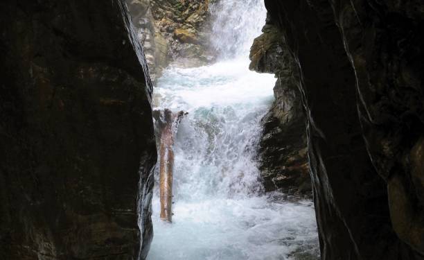 istock wooden walkpath as bridge over cascading waterfall 1345375338