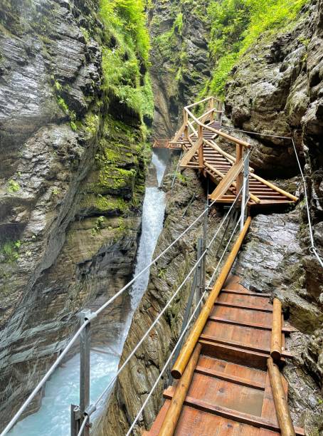 istock wooden walkpath as bridge over cascading waterfall 1345375350