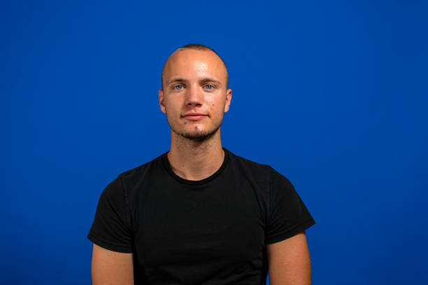 istock Portrait of handsome man standing on blue background 1345375410