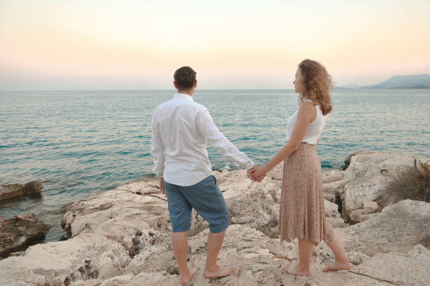 istock Man and woman holding hands 1345376024