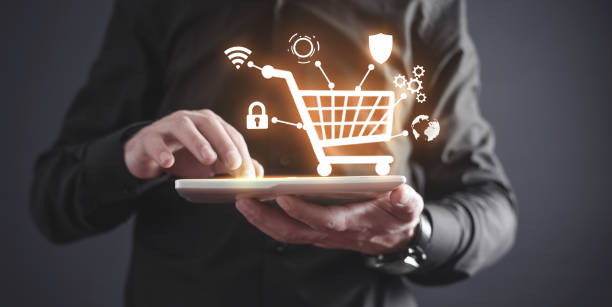 istock Businessman using tablet with shopping cart. E-commerce. Online shopping 1345378176