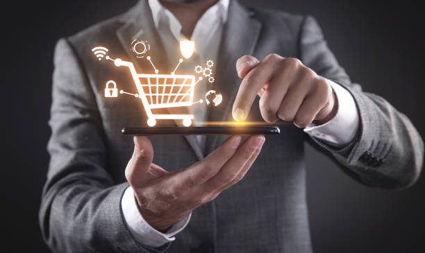 istock Businessman using smartphone with shopping cart. E-commerce. Online shopping 1345378184