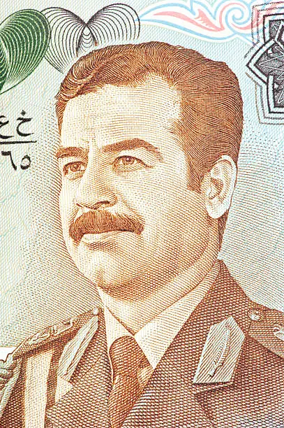 the former iraqi president saddam ussain, wearing military uniform, on a iraqi banknote.