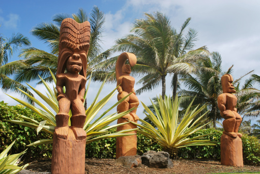 Tiki or Hawaiian God of humanoid forms carved from the wood used to guard the enterance to Hawaiian temples. Photo is taken at Polynesian Culture Center entrance in Oahu.