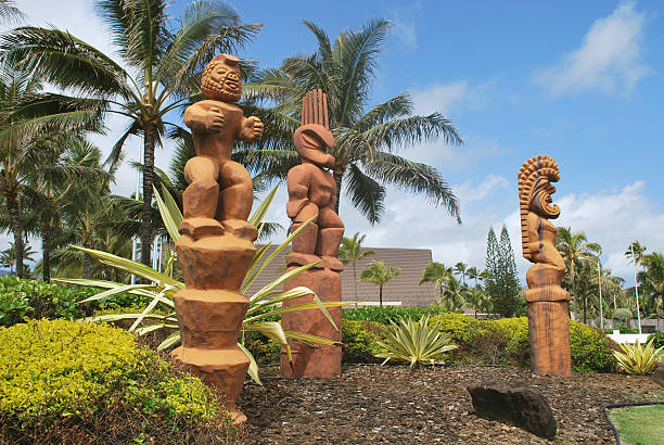 Tiki or Hawaiian God of humanoid form is carved from the wood. Photo is taken at Polynesian Culture Center entrance in Oahu.