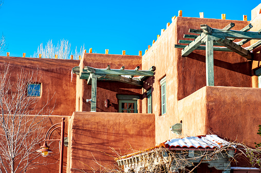 Examples of adobe architecture in Taos Pueblo, New Mexico, a multistory adobe complex inhabited by Native Americans for centuries. A longtime artist colony, Taos also offers many galleries and museums showcasing regional artwork, including the Harwood Museum of Art and the Taos Art Museum.  This is a popular tourist destination for travelers to the Sant Fe area.