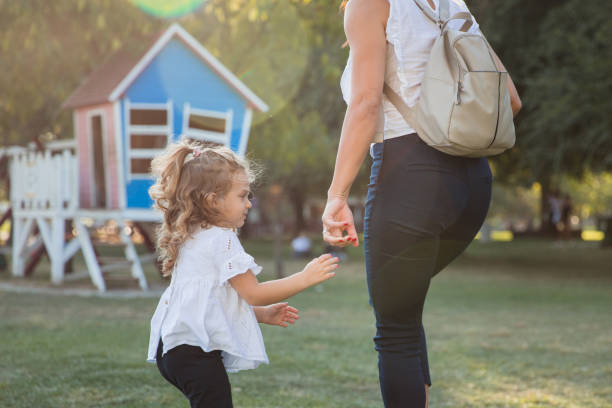 istock Woman taking her daughter to playground 1345380141