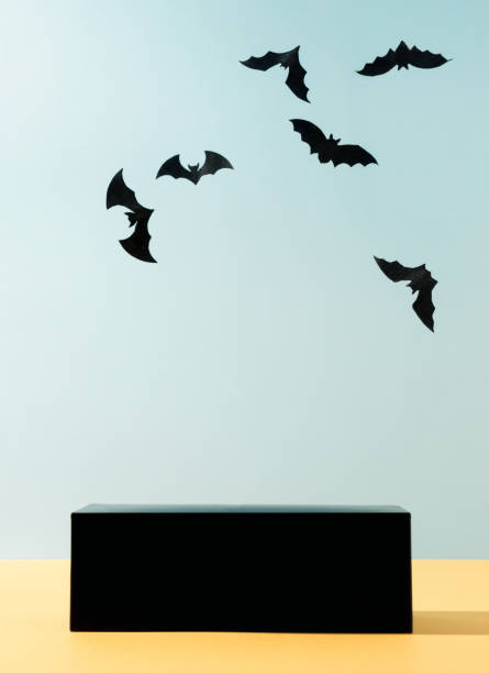 istock Modern product display on sky blue background with podium and bats silhouettes. Suitable for Product Display and Business Concept. Trendy Halloween background. 1345381579